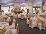 Ballroom with gold table settings