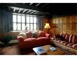 The C17th oak panelled living room with open fire